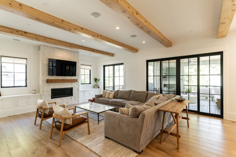 Rosedale earthy tone living room with natural wood and stone fireplace